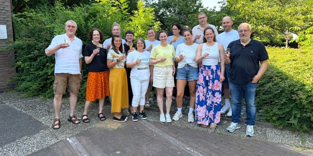 Die Abschlussgruppe UK-Coach© 2026 stößt gemeinsam im Freien an